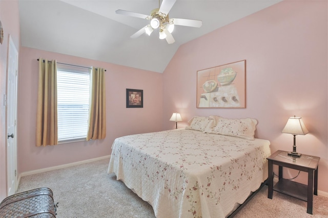 carpeted bedroom with ceiling fan and vaulted ceiling