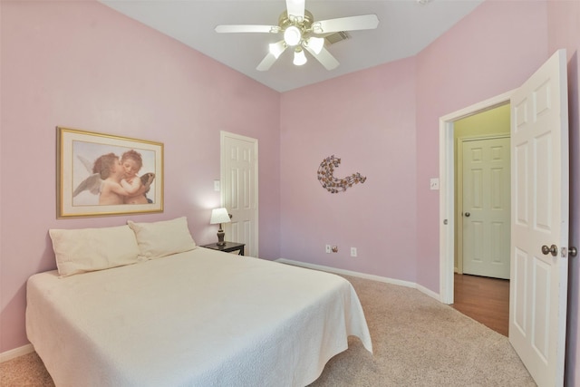 bedroom with ceiling fan and light carpet