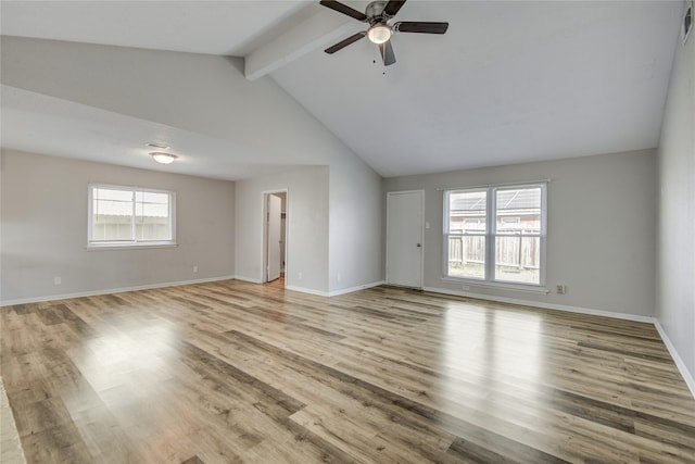 unfurnished living room featuring ceiling fan, light hardwood / wood-style floors, and vaulted ceiling with beams