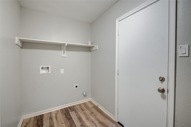 clothes washing area with electric dryer hookup, hookup for a washing machine, and light wood-type flooring