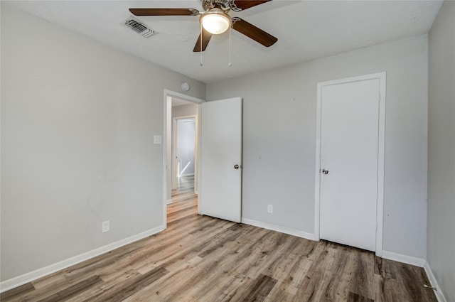 unfurnished bedroom featuring ceiling fan and light hardwood / wood-style floors