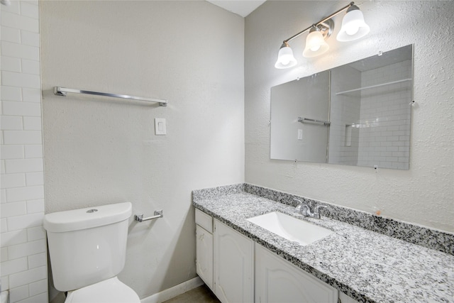 bathroom featuring vanity, toilet, and walk in shower