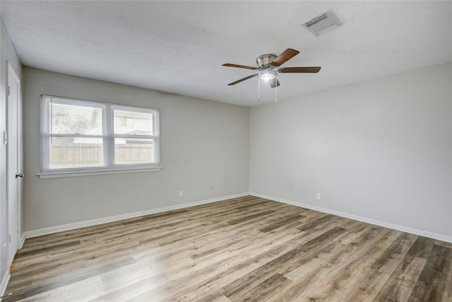 unfurnished room with ceiling fan and light wood-type flooring