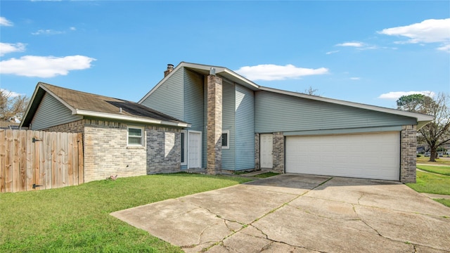 view of front of home with a garage and a front lawn