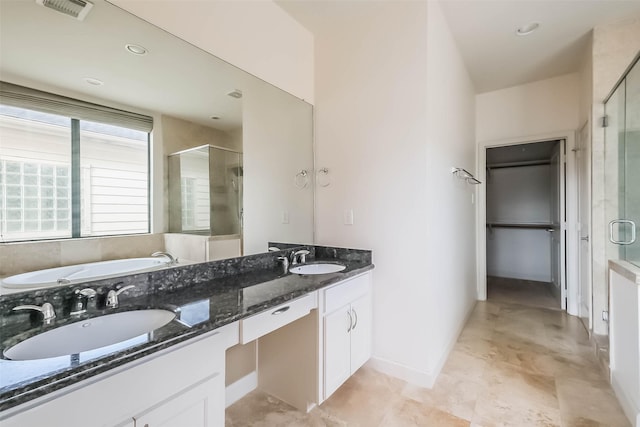 bathroom with vanity and a shower with shower door