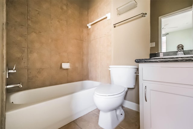 full bathroom featuring vanity, tile patterned floors, toilet, and tiled shower / bath