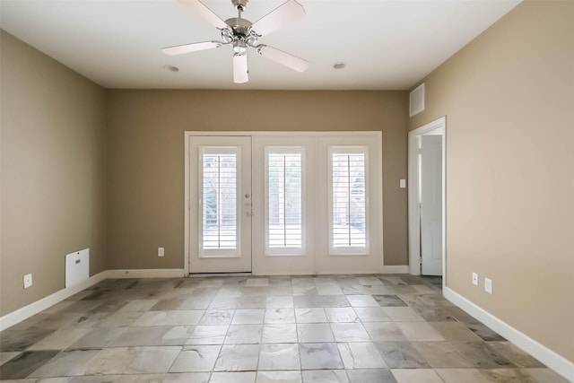 spare room with french doors and ceiling fan