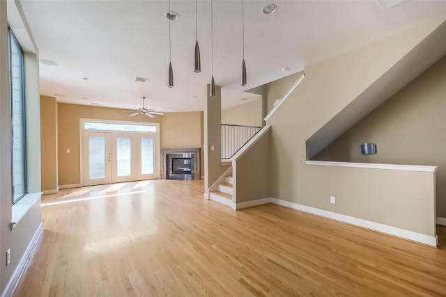 unfurnished living room with light hardwood / wood-style floors and ceiling fan