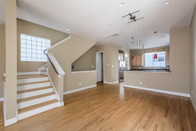 unfurnished living room featuring light wood-type flooring