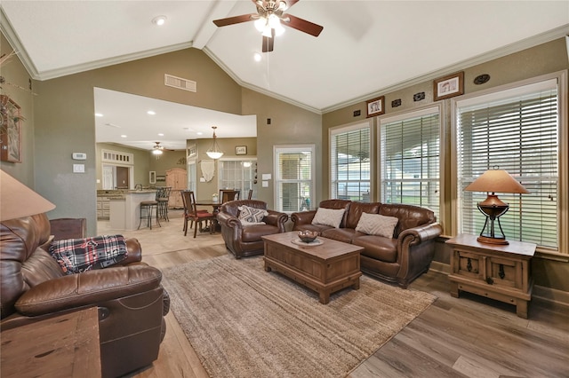 living room with ceiling fan, high vaulted ceiling, ornamental molding, beamed ceiling, and light wood-type flooring