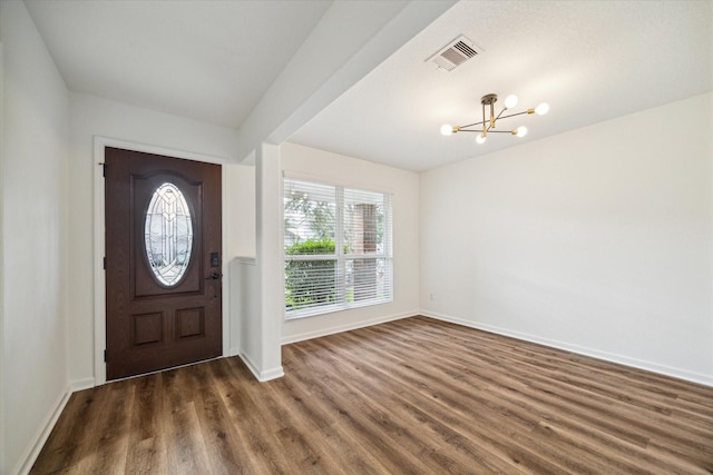 foyer featuring dark hardwood / wood-style flooring and a chandelier