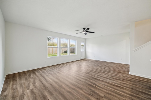 spare room featuring dark wood-type flooring and ceiling fan