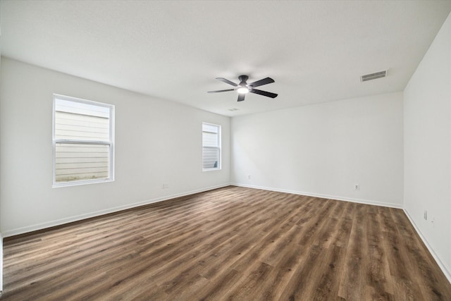 spare room with dark hardwood / wood-style floors and ceiling fan