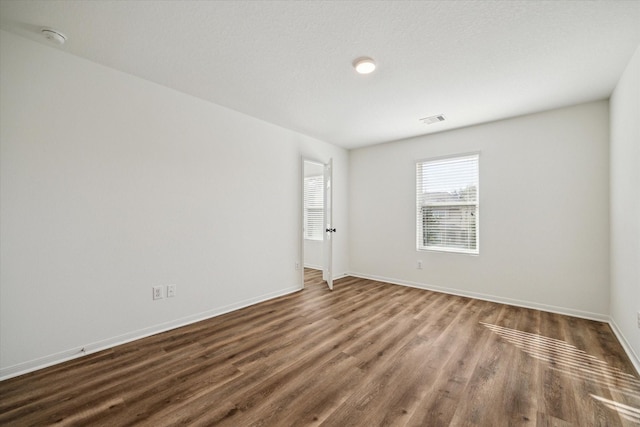 unfurnished room featuring dark hardwood / wood-style floors