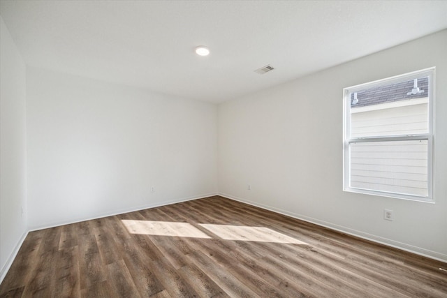 empty room with dark wood-type flooring