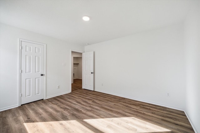 unfurnished bedroom with hardwood / wood-style flooring