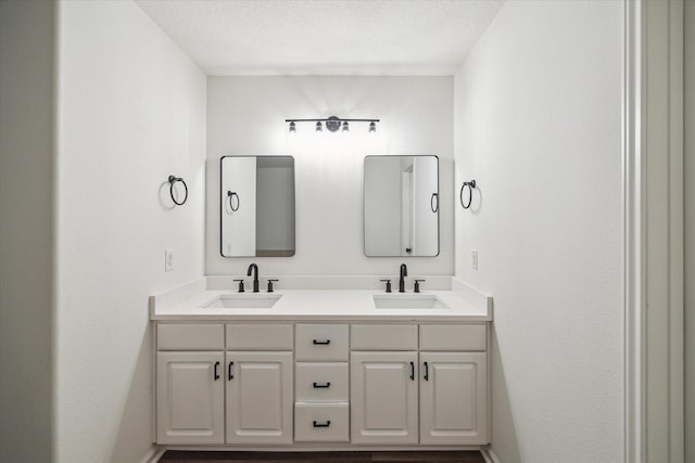 bathroom with vanity and a textured ceiling