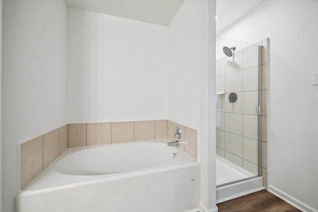 bathroom featuring separate shower and tub and hardwood / wood-style floors