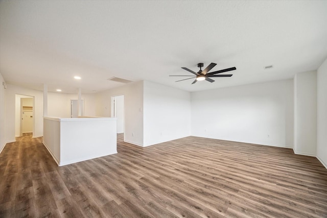 unfurnished living room with dark hardwood / wood-style floors and ceiling fan