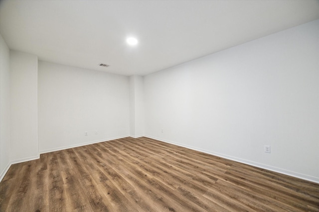 spare room with dark hardwood / wood-style flooring