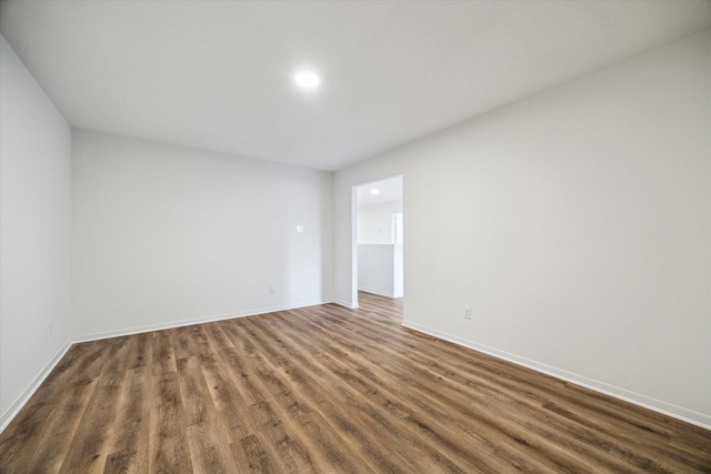 unfurnished room featuring dark hardwood / wood-style flooring