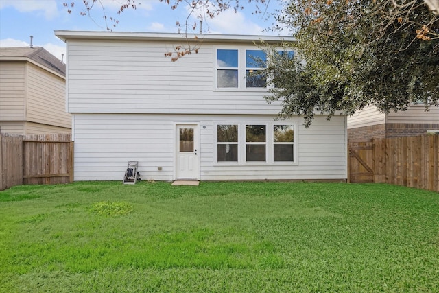 rear view of property with a lawn