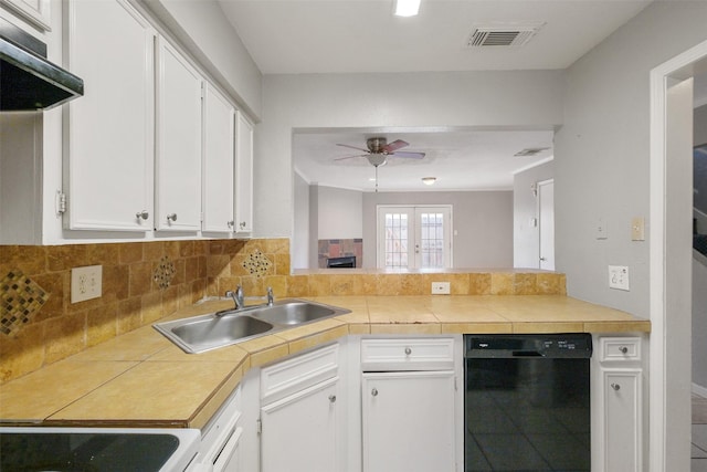 kitchen featuring sink, white cabinetry, tile countertops, black dishwasher, and decorative backsplash