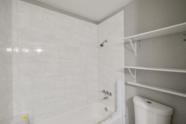 bathroom featuring toilet and tiled shower / bath