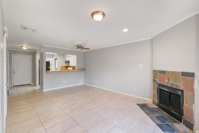 unfurnished living room with a tiled fireplace, crown molding, light tile patterned flooring, and ceiling fan