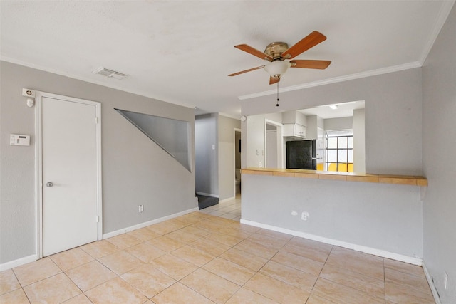 interior space with ornamental molding, light tile patterned floors, and ceiling fan