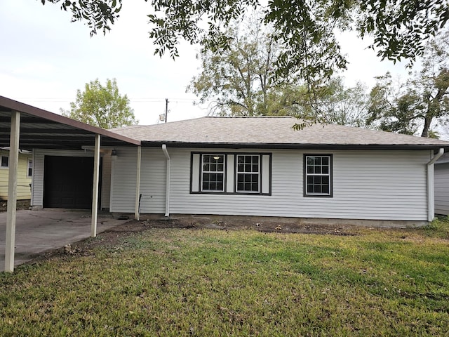 exterior space with a garage, a front lawn, and a carport