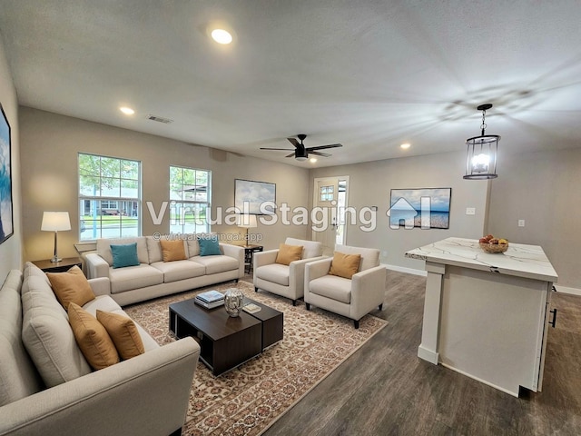 living room with dark hardwood / wood-style flooring and ceiling fan