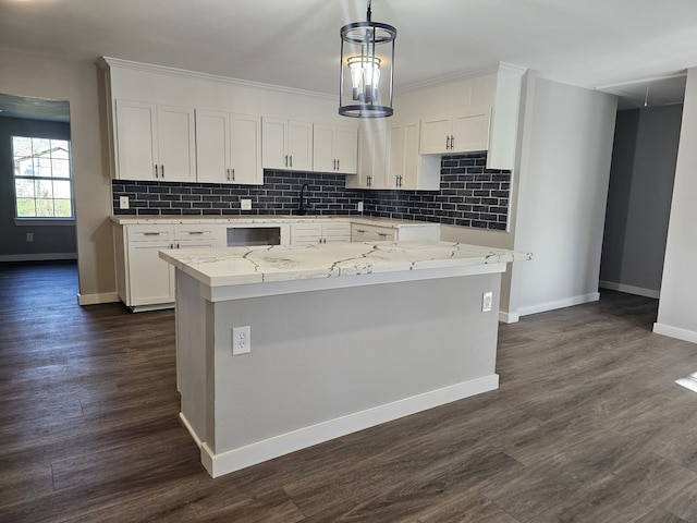 kitchen with a center island, sink, and white cabinets