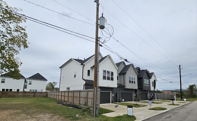 view of property exterior featuring a garage and a yard