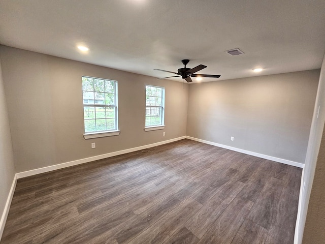 unfurnished room with dark hardwood / wood-style floors and ceiling fan