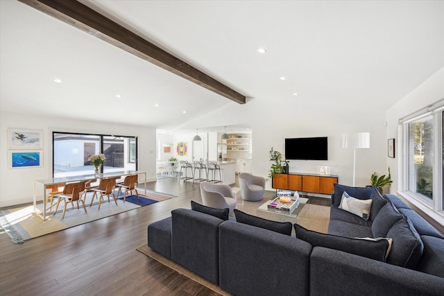 living room with vaulted ceiling with beams and dark wood-type flooring