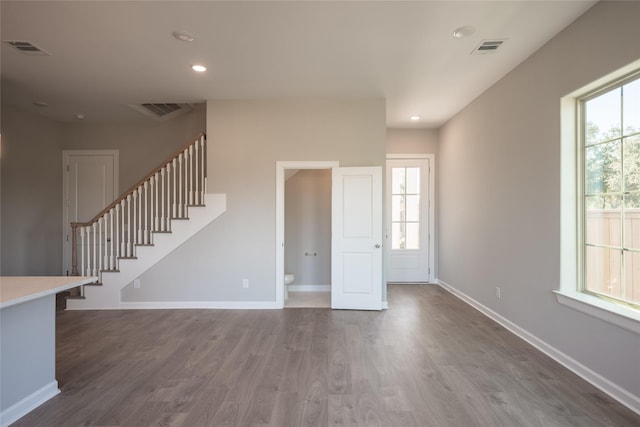 unfurnished living room featuring hardwood / wood-style floors