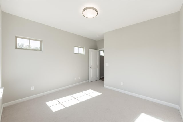 empty room featuring light carpet