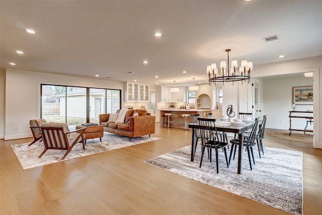 dining room featuring an inviting chandelier and light hardwood / wood-style flooring