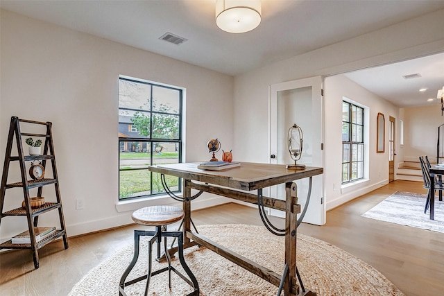 home office with a healthy amount of sunlight and light wood-type flooring