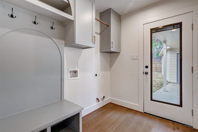 laundry room with cabinets, hookup for a washing machine, hookup for an electric dryer, and light hardwood / wood-style floors