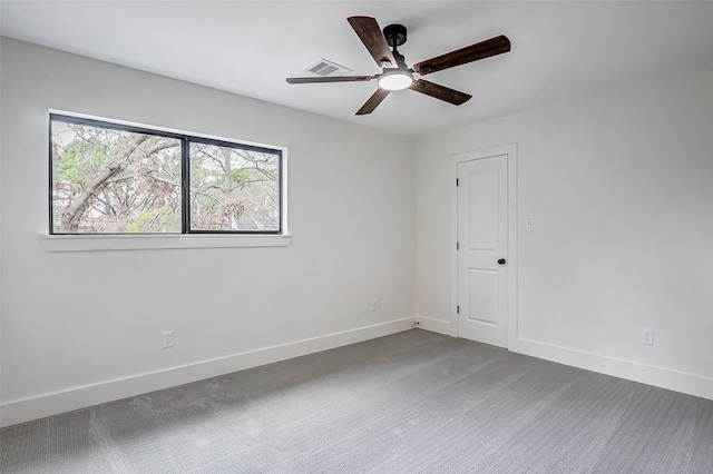 carpeted spare room with ceiling fan