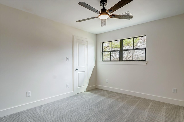 carpeted empty room featuring ceiling fan