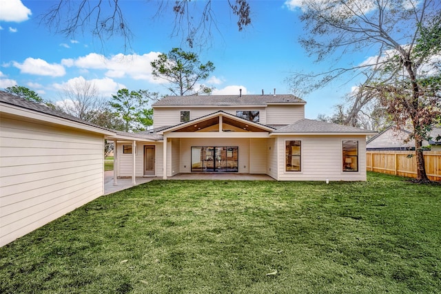 back of house featuring a yard and a patio area