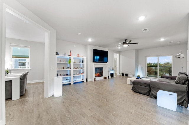 living room featuring ceiling fan and light wood-type flooring