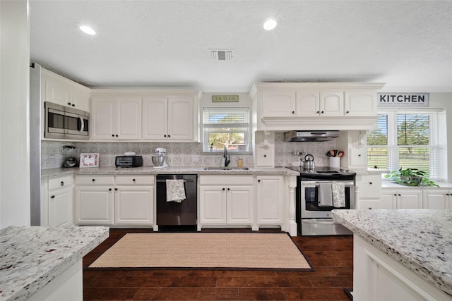 kitchen with sink, stainless steel appliances, extractor fan, light stone countertops, and white cabinets