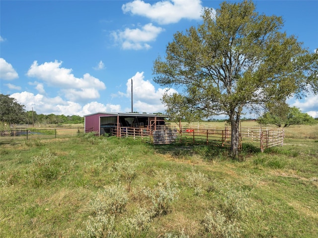 view of yard with an outdoor structure and a rural view