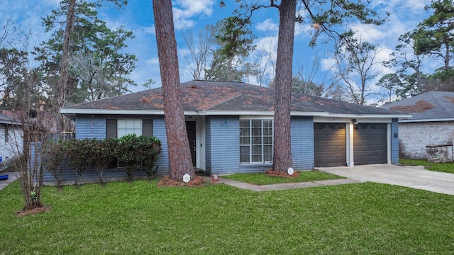 ranch-style house featuring a garage and a front yard