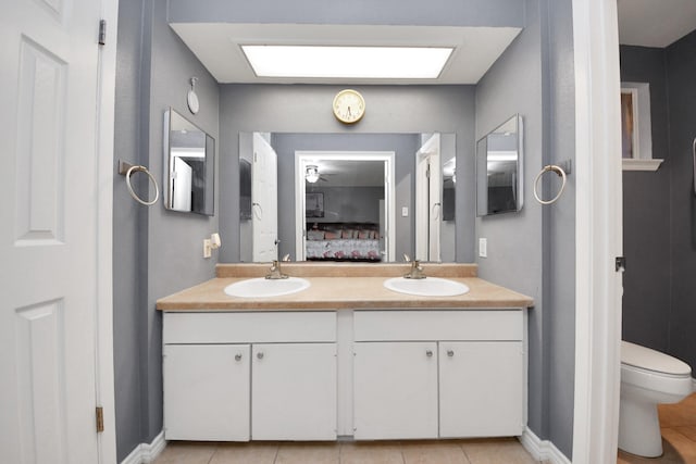 bathroom with vanity, tile patterned floors, and toilet