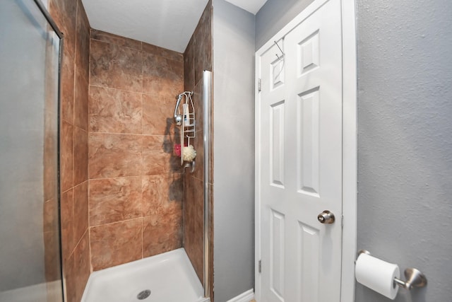 bathroom with tiled shower